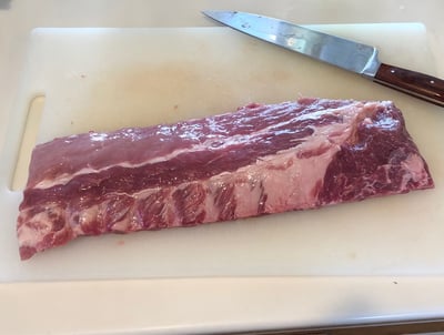 Raw baby back ribs trimmed and ready to cook